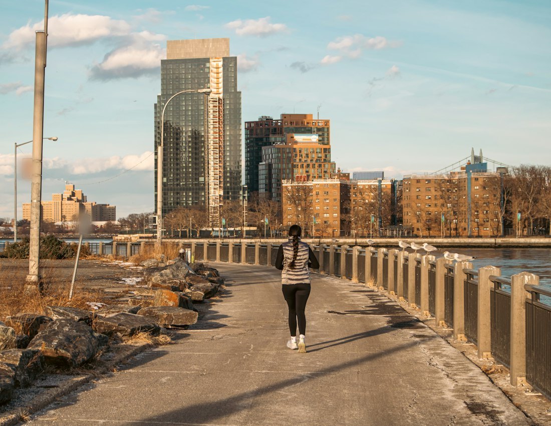 Woman walking along a waterfront path