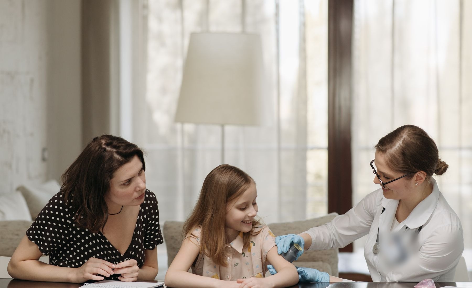 Healthcare provider caring for a child and her mother